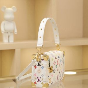 Alternative view of This medium-sized Side Trunk handbag showcases the playful spirit of the Louis Vuitton x Takashi Murakami reissue collection through its whimsical Monogram pattern. Crafted from supple calf leather with reinforced metal corners and the iconic S-lock clasp, it effortlessly holds daily essentials.Its structured silhouette pays homage to the House's classic trunks, while the removable studded handle and shoulder strap offer versatile carrying options. 16 x 8.5 x 23.5 cm (H x W x L)